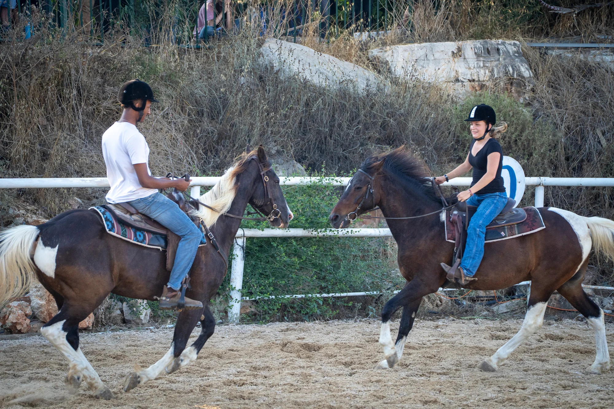 Two riders with their horses in the arena at Eshbal
